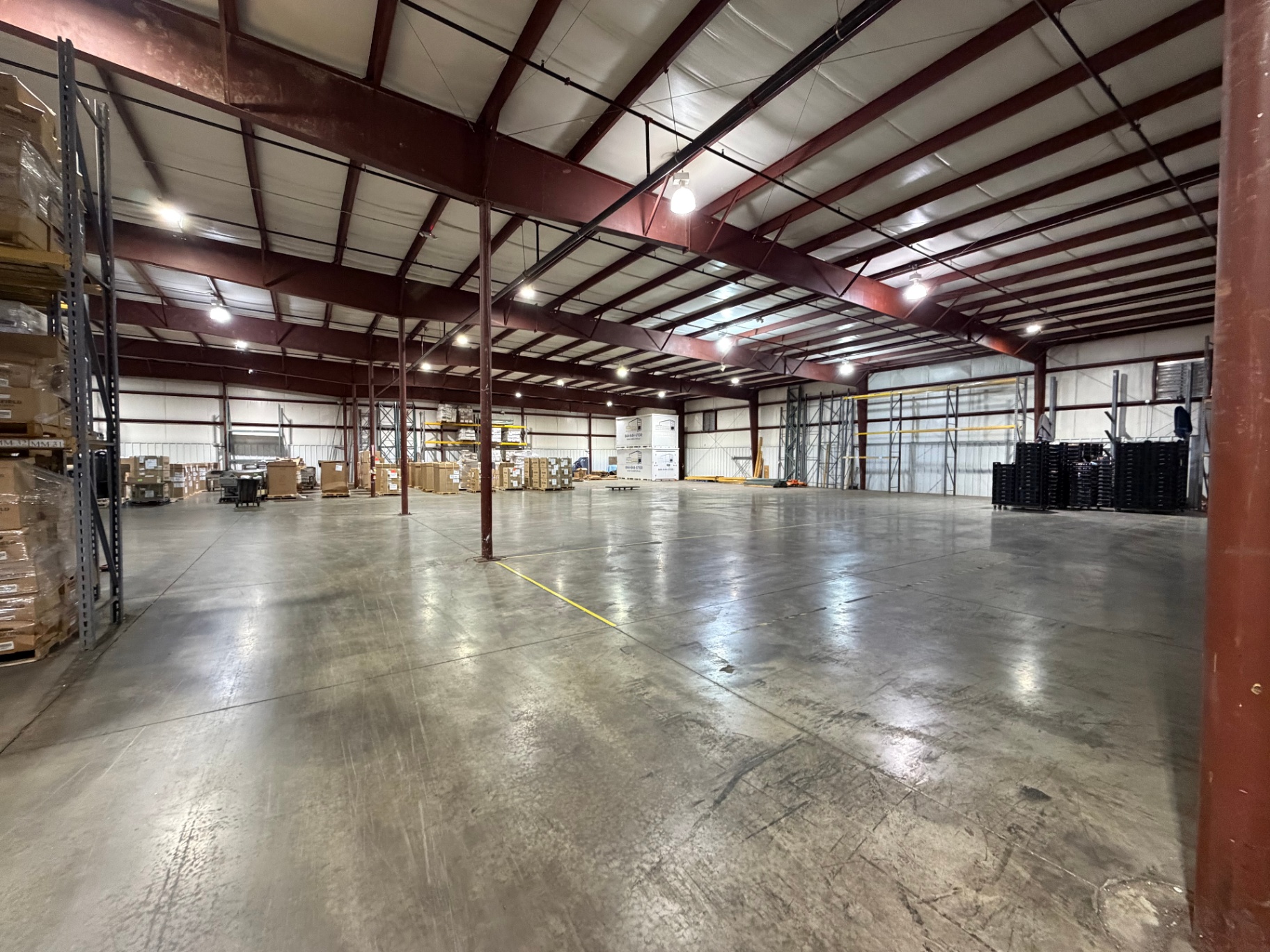 Interior of MobiStor's heated warehouse with polished concrete floors, high ceilings, and pallet racking