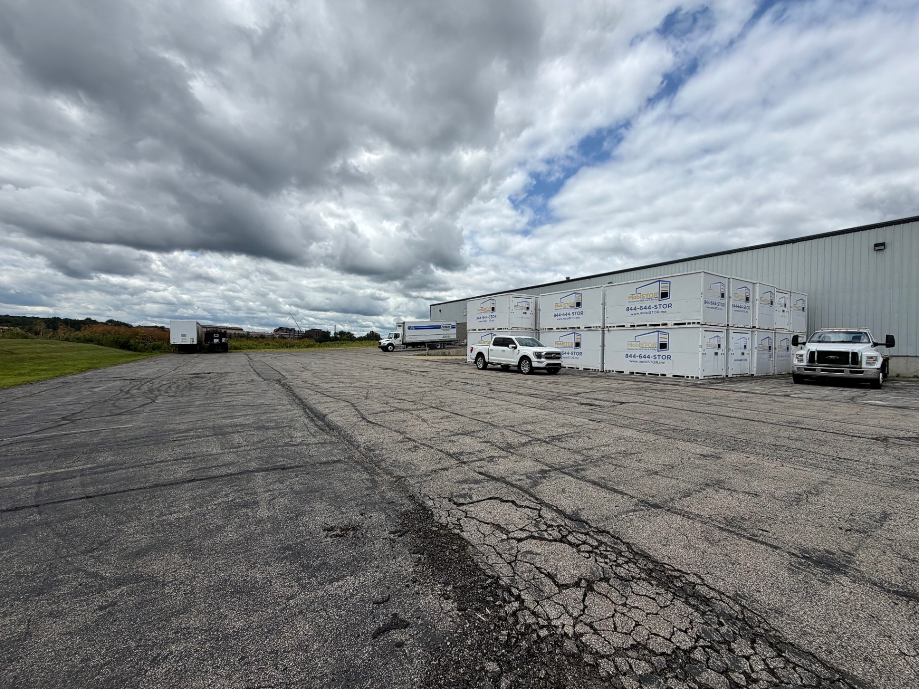 Exterior of the Mansfield facility with stacked MobiStor containers and service trucks
